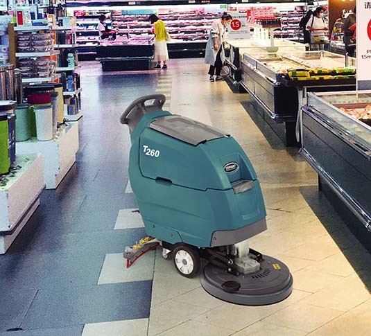 T260 Walk-Behind Floor Scrubber cleaning in a grocery story